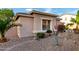 Charming single-story home with desert landscaping and manicured bushes at 9908 E Medina Ave, Mesa, AZ 85209