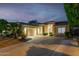 Exterior home view at twilight with wide driveway and two-car garage at 9908 E Medina Ave, Mesa, AZ 85209