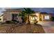 Charming single-story home exterior view showcasing landscape at twilight at 9908 E Medina Ave, Mesa, AZ 85209