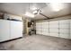 This garage boasts ample space, a bright overhead light, and additional storage for household items and tools at 9908 E Medina Ave, Mesa, AZ 85209
