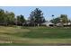 Lush green golf course with mature trees and houses in the background, creating a serene and upscale community vibe at 9908 E Medina Ave, Mesa, AZ 85209