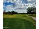 Expansive view of a beautifully maintained golf course with rolling greens and a winding cart path at 9908 E Medina Ave, Mesa, AZ 85209