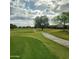 Picturesque golf course scene with a smooth cart path winding through the manicured green landscape at 9908 E Medina Ave, Mesa, AZ 85209