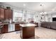 Updated kitchen featuring a center island, stainless steel appliances, dark cabinetry, and tiled floors at 9908 E Medina Ave, Mesa, AZ 85209