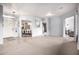 Spacious living room with tiled floors, neutral carpeting, and views of the dining room and kitchen at 9908 E Medina Ave, Mesa, AZ 85209