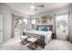 Spacious main bedroom with ample natural light, stylish decor, and a comfortable seating area at 9908 E Medina Ave, Mesa, AZ 85209