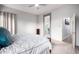 Cozy main bedroom with a plush bed, soft carpet, and ensuite bathroom access at 9908 E Medina Ave, Mesa, AZ 85209