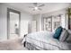 Bright main bedroom with large windows, neutral tones, and a modern ceiling fan at 9908 E Medina Ave, Mesa, AZ 85209