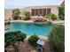Inviting backyard pool and spa boasts rock features, lush tropical landscaping and private fencing at 9908 E Medina Ave, Mesa, AZ 85209