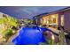 Backyard oasis with inviting swimming pool, rock waterfall features, and outdoor lounge with a fire pit at 9908 E Medina Ave, Mesa, AZ 85209
