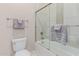 Bright bathroom featuring a shower-tub combination with glass doors and modern fixtures at 10713 N 124Th Pl, Scottsdale, AZ 85259