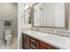Well-lit bathroom featuring a dual sink vanity, mosaic backsplash, and plenty of storage at 10713 N 124Th Pl, Scottsdale, AZ 85259