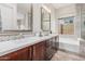 Elegant bathroom featuring double sinks, quartz counters, and modern fixtures at 10713 N 124Th Pl, Scottsdale, AZ 85259
