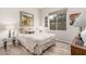 Cozy bedroom with a large window and decorative painting on the wall at 10713 N 124Th Pl, Scottsdale, AZ 85259