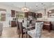 Open-concept kitchen and dining area featuring stainless appliances, granite counters, and natural light at 10713 N 124Th Pl, Scottsdale, AZ 85259