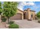 Charming home showcasing a well-maintained front yard and a spacious two-car garage at 10713 N 124Th Pl, Scottsdale, AZ 85259