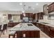 Large kitchen with granite countertops, stainless appliances, a central island with barstool seating, and tile flooring at 10713 N 124Th Pl, Scottsdale, AZ 85259