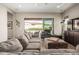 Spacious living room with neutral tones, wood floors, and sliding glass doors to the backyard patio at 10713 N 124Th Pl, Scottsdale, AZ 85259