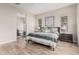 The primary bedroom has wood tile floors and ensuite bathroom with tub at 10713 N 124Th Pl, Scottsdale, AZ 85259