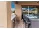 Covered patio featuring a built-in grill, bar seating, and seamless indoor/outdoor flow at 10713 N 124Th Pl, Scottsdale, AZ 85259