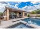Stunning backyard featuring a refreshing pool, covered patio with a fireplace, and lush landscaping at 10713 N 124Th Pl, Scottsdale, AZ 85259