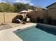Relaxing outdoor space with a refreshing pool, lounge chairs, and shade umbrella at 10713 N 124Th Pl, Scottsdale, AZ 85259