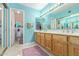 Bright bathroom with double sink vanity, neutral tile, and stylish purple rugs at 1114 W Meseto Ave, Mesa, AZ 85210