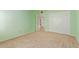 Bright green bedroom featuring neutral carpet and closet with mirrored doors at 1114 W Meseto Ave, Mesa, AZ 85210