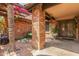 Charming courtyard entrance with brick pillar and ornate wrought-iron doors in this lovely home at 1114 W Meseto Ave, Mesa, AZ 85210