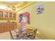Charming dining area adjacent to the kitchen, complete with a glass-top table and stylish chairs at 1114 W Meseto Ave, Mesa, AZ 85210