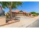 Inviting home with three-car garage, clay tile roof, mature shade trees, and charming courtyard entry at 1114 W Meseto Ave, Mesa, AZ 85210