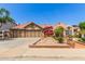 Charming single-story home boasts a clay tile roof, inviting courtyard entry, and three-car garage at 1114 W Meseto Ave, Mesa, AZ 85210