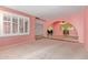 Bright living room features plush carpeting and large window, seamlessly connects to other living spaces at 1114 W Meseto Ave, Mesa, AZ 85210