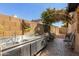 An outdoor kitchen area with a stainless steel countertop, sink, and colorful wall decor at 1114 W Meseto Ave, Mesa, AZ 85210