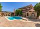 Backyard view of the pool, patio area, and solar panels on the house's roof at 1114 W Meseto Ave, Mesa, AZ 85210