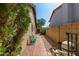 A side yard with gravel landscaping, a tiled walkway, and access to the backyard at 1114 W Meseto Ave, Mesa, AZ 85210