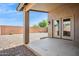 Covered patio area looks out over a low-maintenance backyard, with gravel and block wall at 11351 N 153Rd Dr, Surprise, AZ 85379