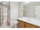 Bathroom with a single sink vanity, large mirror, and tile flooring, offering a clean and functional space at 11351 N 153Rd Dr, Surprise, AZ 85379