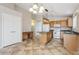 Bright kitchen boasts an island, modern lighting fixtures, and seamless flow into other living areas for easy entertaining at 11351 N 153Rd Dr, Surprise, AZ 85379