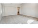 Spacious living room featuring neutral carpet, an arched doorway, and access to other rooms through tiled flooring at 11351 N 153Rd Dr, Surprise, AZ 85379