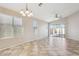 Open-concept living area with sliding glass doors, tiled flooring, and a ceiling fan for added comfort and appeal at 11351 N 153Rd Dr, Surprise, AZ 85379