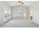 Bright living room with neutral carpet, a bay window, and a door to the outside that welcomes ample natural light at 11351 N 153Rd Dr, Surprise, AZ 85379