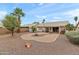 Expansive backyard with gravel landscaping, mature trees, and a cozy fire pit, perfect for outdoor living at 11925 N 67Th Dr, Peoria, AZ 85345