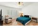 Comfortable bedroom with a ceiling fan, shutters, tiled flooring and a cozy recliner at 11925 N 67Th Dr, Peoria, AZ 85345