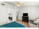 Spacious bedroom featuring tiled floors, ceiling fan, recliner, and an ensuite bathroom at 11925 N 67Th Dr, Peoria, AZ 85345