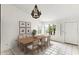 Bright dining room with wood table, chandelier, and large windows offering scenic views at 11925 N 67Th Dr, Peoria, AZ 85345