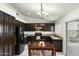 Cozy kitchen featuring dark cabinetry, granite countertops, and a dining area at 11925 N 67Th Dr, Peoria, AZ 85345
