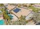 Aerial view of a home featuring a pool, spa, solar panels, and well-maintained landscaping at 12749 E Poinsettia Dr, Scottsdale, AZ 85259