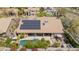 Stunning aerial view of a home featuring a sparkling pool, solar panels, covered patio, and lush landscaping at 12749 E Poinsettia Dr, Scottsdale, AZ 85259