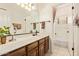Well-lit bathroom featuring a vanity with dark cabinets and a separate shower room at 12749 E Poinsettia Dr, Scottsdale, AZ 85259
